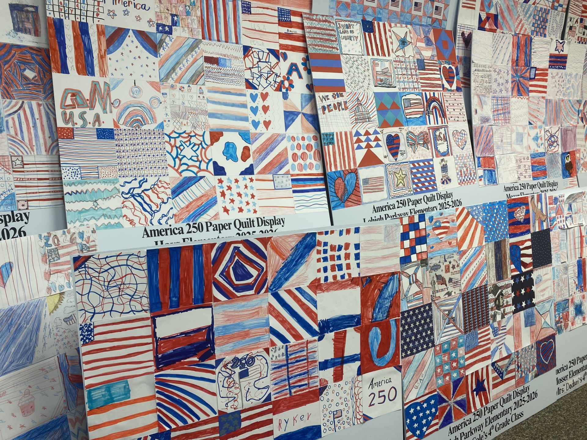 Student-made red white and blue quilts